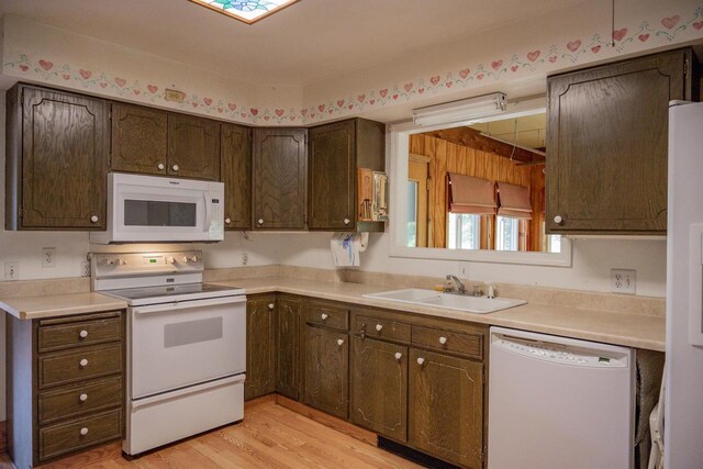 1930 Czech Ave, Arkdale, WI 54613 - kitchen featuring light countertops, a sink, light wood-style floors, and white appliances