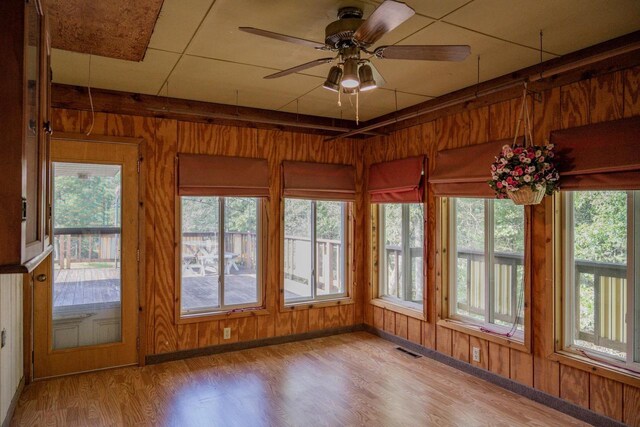 1930 Czech Ave, Arkdale, WI 54613 - unfurnished sunroom featuring wood finished floors, wood walls, and visible vents