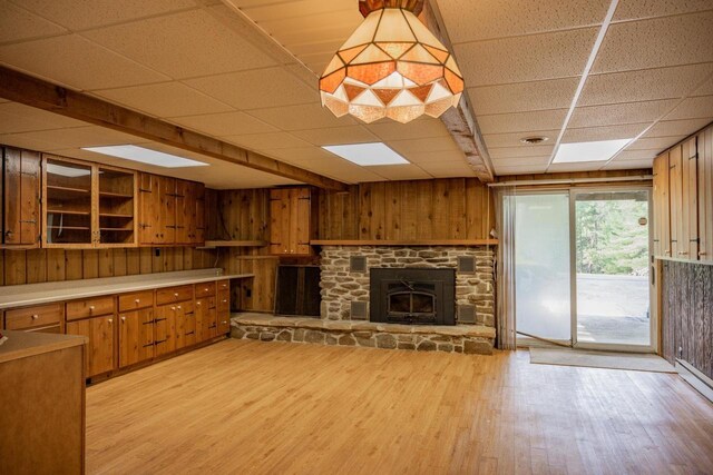 1930 Czech Ave, Arkdale, WI 54613 - interior space with a fireplace, light wood-style floors, wood walls, and a drop ceiling