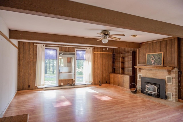 1930 Czech Ave, Arkdale, WI 54613 - unfurnished living room with baseboard heating, wood finished floors, a wood stove, and wood walls