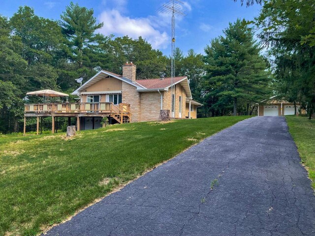 1930 Czech Ave, Arkdale, WI 54613 - view of side of property featuring an outdoor structure, a chimney, a wooden deck, a garage, and a lawn