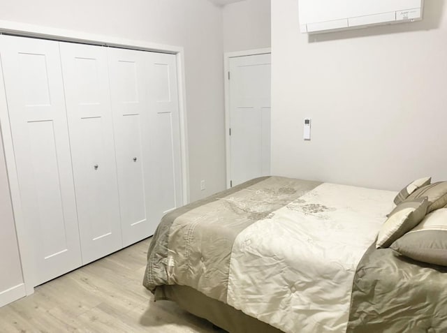 1501 N Windsor Ave Unit 205, Cottage Grove, WI 53527 - bedroom with light wood-type flooring, an AC wall unit, and a closet