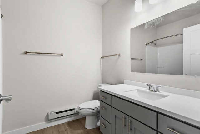 1501 N Windsor Ave Unit 205, Cottage Grove, WI 53527 - full bathroom featuring a baseboard heating unit, wood finished floors, vanity, and a shower
