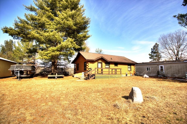 N16180 Deerfield Dr, Nekoosa, WI 54457 - rear view of house with log siding, a lawn, and a deck