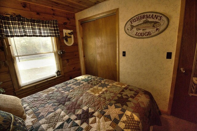 N16180 Deerfield Dr, Nekoosa, WI 54457 - bedroom with a closet, wallpapered walls, and wood ceiling