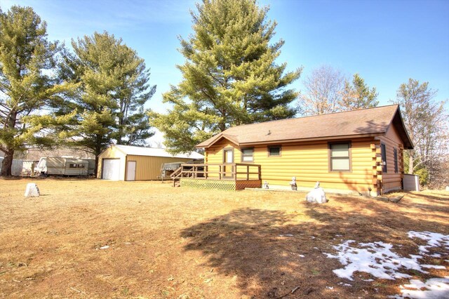 N16180 Deerfield Dr, Nekoosa, WI 54457 - rear view of property with an outdoor structure, log siding, a garage, and a deck