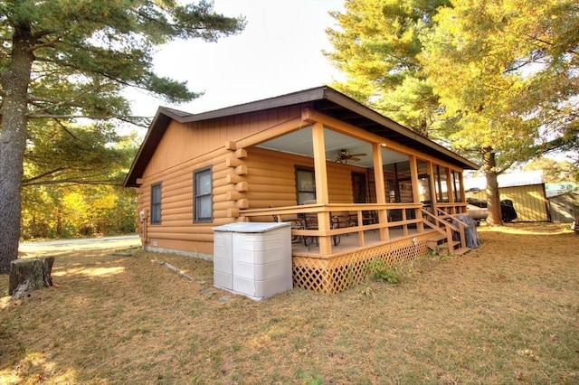 N16180 Deerfield Dr, Nekoosa, WI 54457 - exterior space with log siding, ceiling fan, and a yard