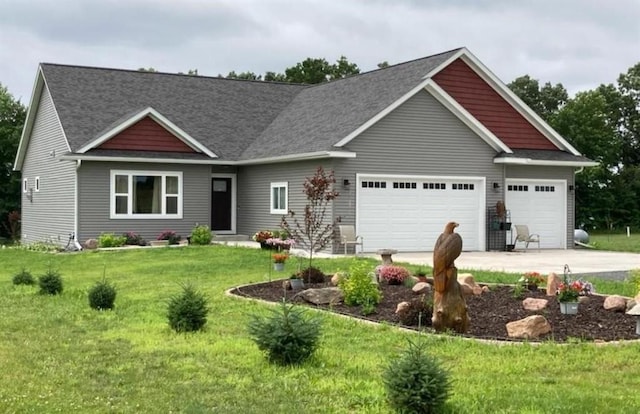 craftsman inspired home with a front yard, a garage, and concrete driveway