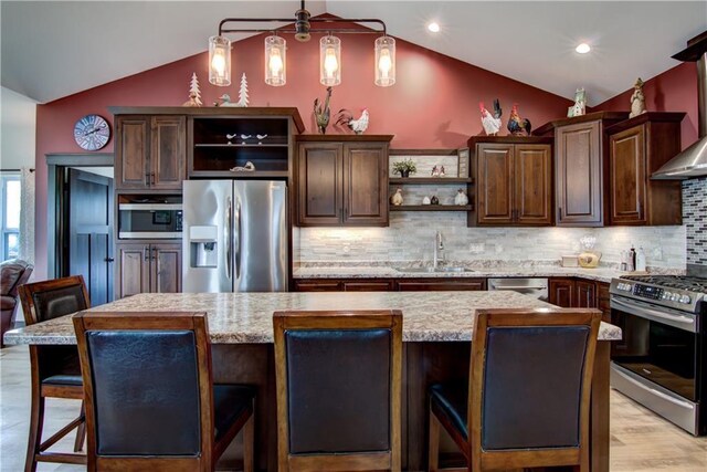 kitchen featuring vaulted ceiling, dark brown cabinetry, a sink, open shelves, and appliances with stainless steel finishes