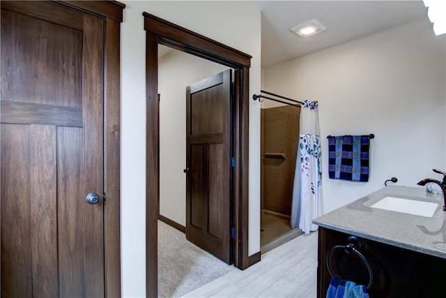 bathroom featuring vanity and a shower with shower curtain