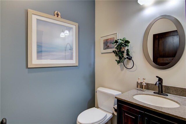 bathroom featuring toilet and vanity