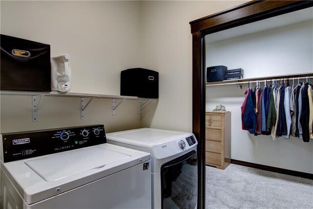 clothes washing area with baseboards, laundry area, separate washer and dryer, and light colored carpet