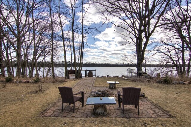 view of yard featuring a water view and a patio area