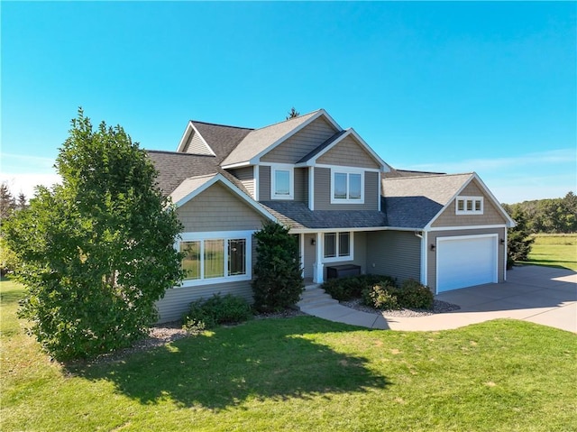 4884 Priory Rd, Eau Claire, WI 54701 - craftsman house with driveway, a shingled roof, an attached garage, and a front lawn