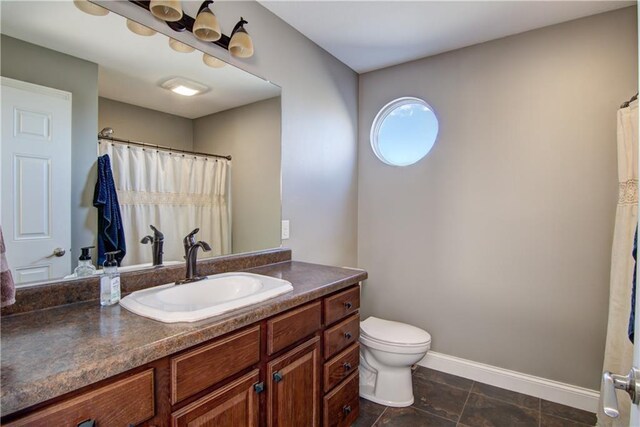 4884 Priory Rd, Eau Claire, WI 54701 - full bath featuring baseboards, toilet, and vanity