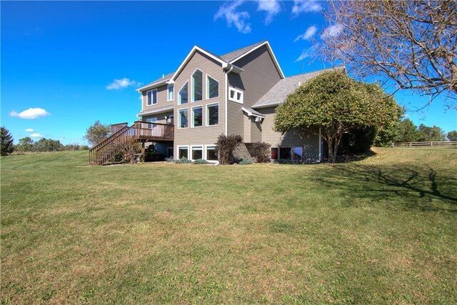 4884 Priory Rd, Eau Claire, WI 54701 - rear view of property featuring fence, stairs, a wooden deck, a shingled roof, and a yard