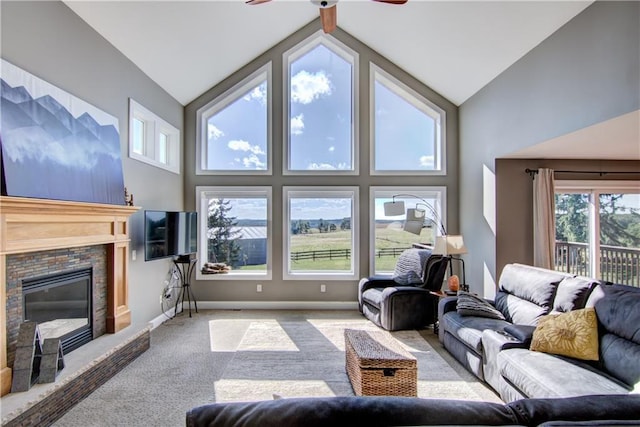 4884 Priory Rd, Eau Claire, WI 54701 - living area featuring high vaulted ceiling, a glass covered fireplace, baseboards, ceiling fan, and carpet