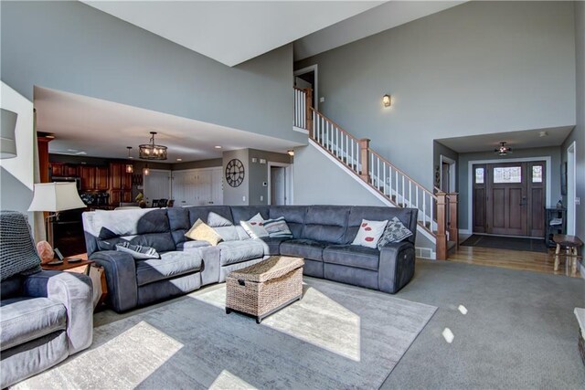 4884 Priory Rd, Eau Claire, WI 54701 - living room featuring stairs, a towering ceiling, and carpet floors