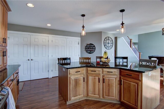 4884 Priory Rd, Eau Claire, WI 54701 - kitchen with hanging light fixtures, recessed lighting, dark stone countertops, and dark wood-style flooring