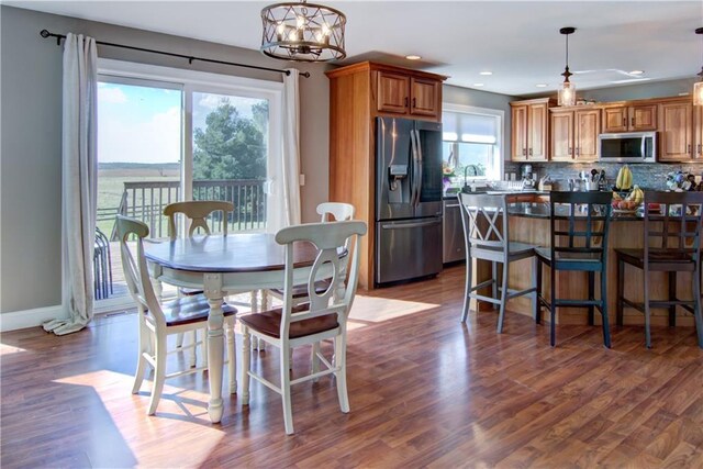4884 Priory Rd, Eau Claire, WI 54701 - dining space with dark wood finished floors, baseboards, recessed lighting, and an inviting chandelier