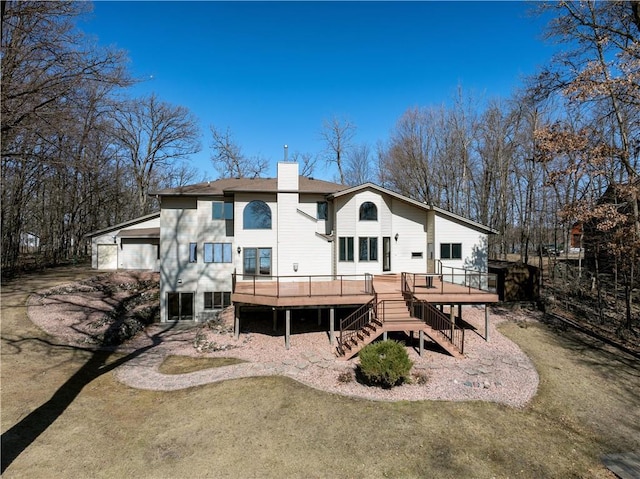 1530 E Orchard Beach Ln, Rice Lake, WI 54868 - rear view of property featuring a wooden deck, stairs, and a chimney