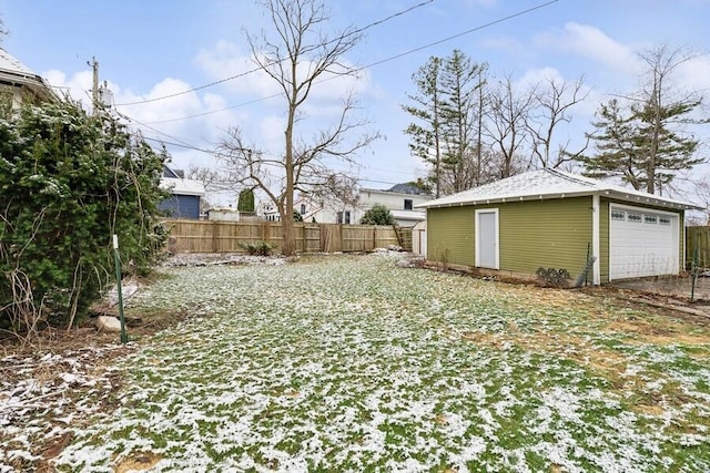 view of yard featuring an outbuilding, fence, and a detached garage