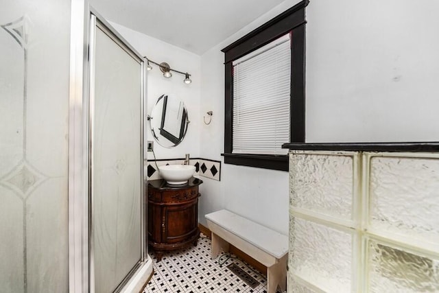 full bath with a stall shower and vanity