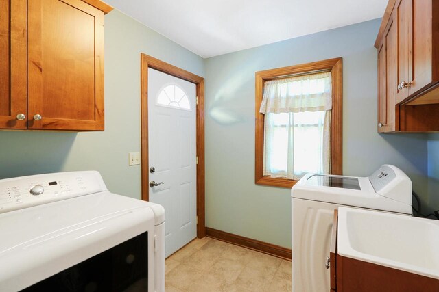 W512 Hafs Rd, Genoa City, WI 53128 - washroom with a sink, cabinet space, baseboards, and washer and dryer