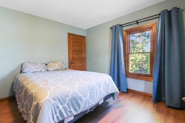 W512 Hafs Rd, Genoa City, WI 53128 - bedroom with baseboards and wood finished floors