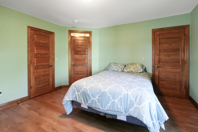 W512 Hafs Rd, Genoa City, WI 53128 - bedroom with baseboards and wood finished floors