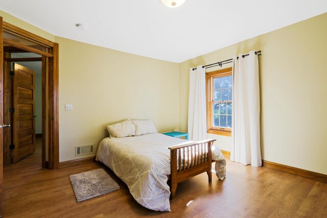 W512 Hafs Rd, Genoa City, WI 53128 - bedroom with baseboards, visible vents, and wood finished floors