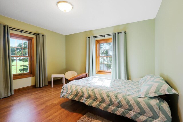 W512 Hafs Rd, Genoa City, WI 53128 - bedroom featuring baseboards, multiple windows, and wood finished floors