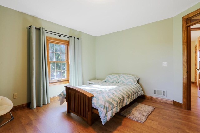 W512 Hafs Rd, Genoa City, WI 53128 - bedroom with wood finished floors, baseboards, and visible vents