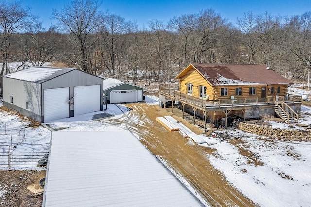 N9805 County Road Aa, Portage, WI 53901 - snow covered property with a wooden deck, an outdoor structure, log siding, and a detached garage