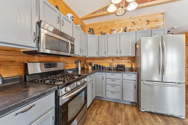 N9805 County Road Aa, Portage, WI 53901 - kitchen with stainless steel appliances, lofted ceiling, dark countertops, wood finished floors, and gray cabinetry