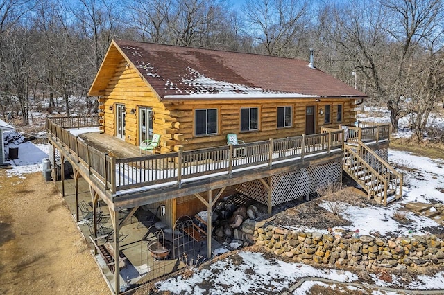 N9805 County Road Aa, Portage, WI 53901 - snow covered rear of property with log exterior, a deck, and stairs