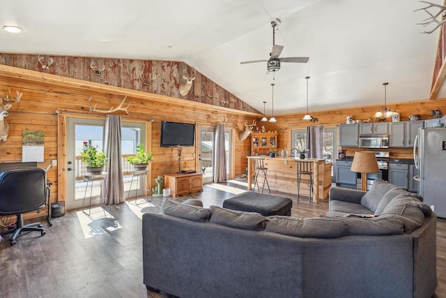 N9805 County Road Aa, Portage, WI 53901 - living room featuring wood finished floors, plenty of natural light, lofted ceiling, a ceiling fan, and wood walls