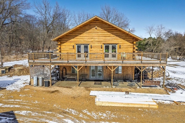 N9805 County Road Aa, Portage, WI 53901 - snow covered property with french doors, log exterior, and a wooden deck