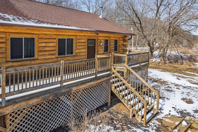 N9805 County Road Aa, Portage, WI 53901 - snow covered property featuring log exterior, a wooden deck, a shingled roof, and stairway