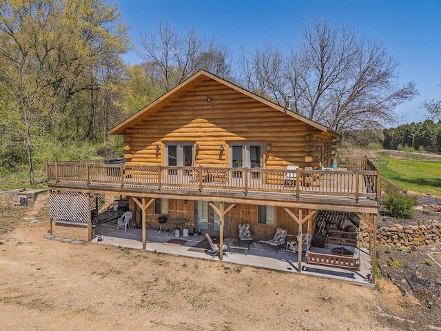 N9805 County Road Aa, Portage, WI 53901 - rear view of house with log exterior, french doors, a patio area, and a wooden deck