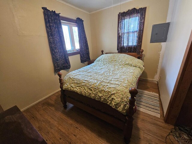 N2709 Lakeshore Dr, Montello, WI 53949 - bedroom with electric panel, baseboards, crown molding, and wood finished floors
