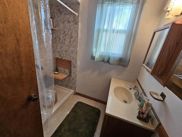 N2709 Lakeshore Dr, Montello, WI 53949 - bathroom with vanity, baseboards, and a tile shower