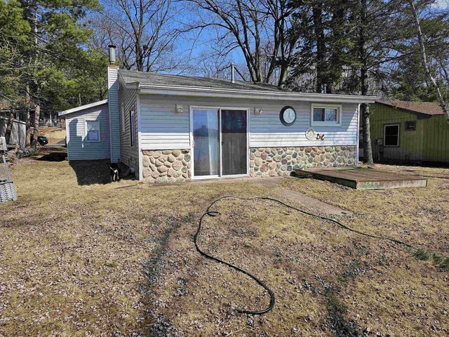N2709 Lakeshore Dr, Montello, WI 53949 - rear view of property with a chimney and stone siding