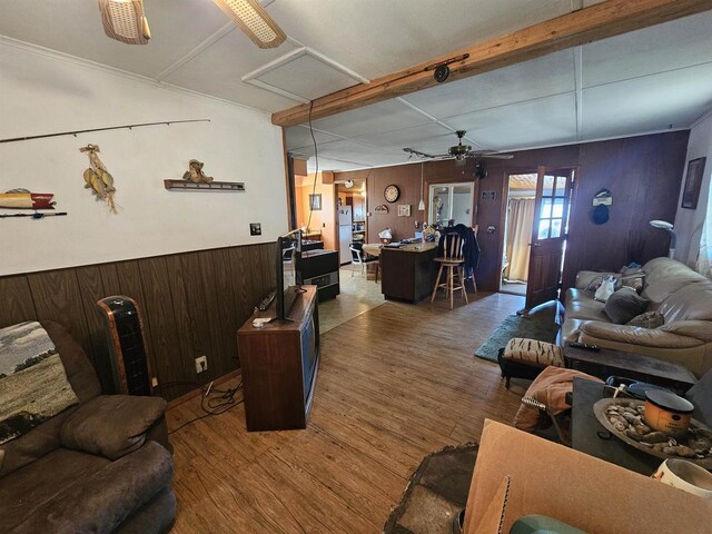 N2709 Lakeshore Dr, Montello, WI 53949 - living room featuring wood finished floors, wood walls, beamed ceiling, a ceiling fan, and wainscoting