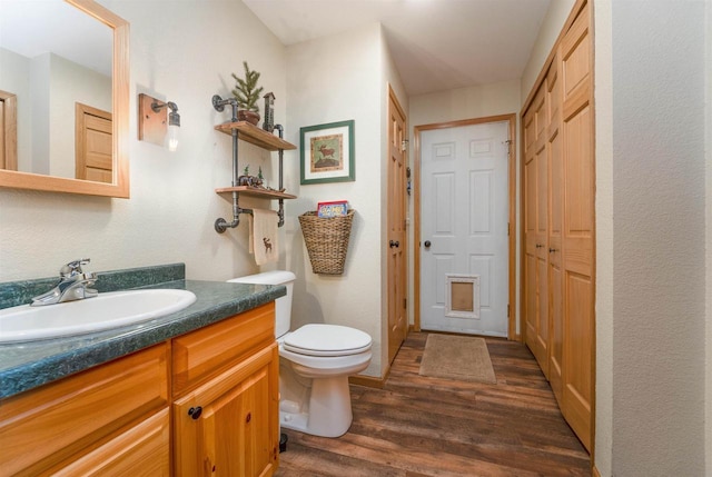 W7113 Bighorn Ct, Wautoma, WI 54982 - bathroom with toilet, wood finished floors, and vanity