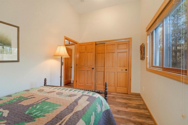 W7113 Bighorn Ct, Wautoma, WI 54982 - bedroom featuring baseboards, a high ceiling, and wood finished floors