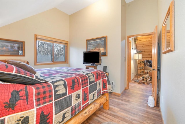 W7113 Bighorn Ct, Wautoma, WI 54982 - bedroom featuring high vaulted ceiling, baseboards, and wood finished floors