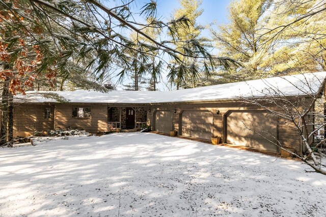 view of snow covered back of property