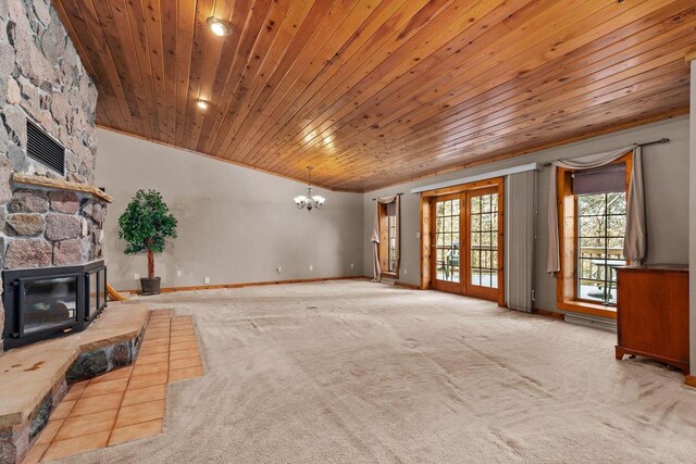 unfurnished living room featuring wood ceiling, carpet flooring, a chandelier, a fireplace, and baseboards
