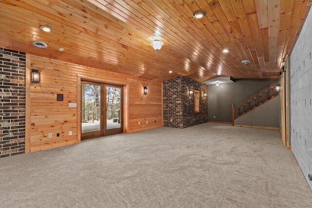 unfurnished living room with french doors, wood ceiling, wood walls, and carpet floors